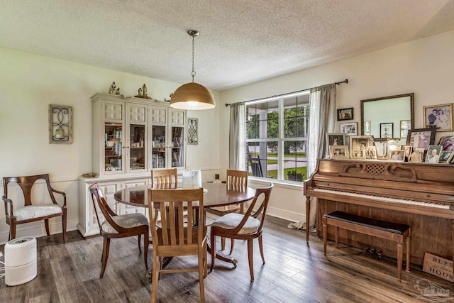 2519 Inda Ave, Pensacola, FL 32526 - dining area with a textured ceiling, dark wood-type flooring, and baseboards