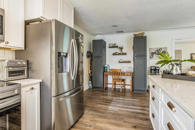 2519 Inda Ave, Pensacola, FL 32526 - kitchen featuring visible vents, a toaster, stainless steel appliances, a textured ceiling, and dark wood-style flooring