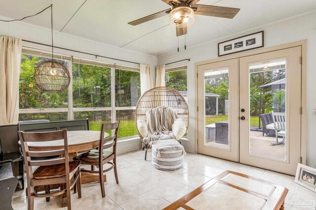 sunroom / solarium featuring ceiling fan and french doors