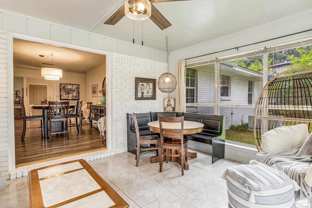 2519 Inda Ave, Pensacola, FL 32526 - dining area featuring light tile patterned floors, plenty of natural light, brick wall, and ceiling fan