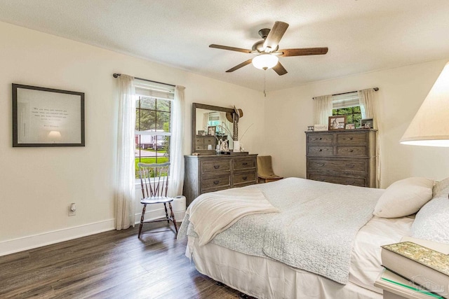 bedroom with a textured ceiling, dark hardwood / wood-style flooring, and ceiling fan