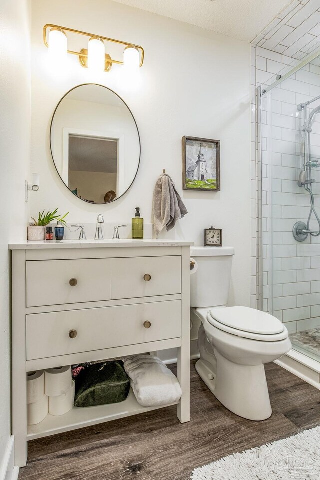 2519 Inda Ave, Pensacola, FL 32526 - bathroom with a stall shower, toilet, wood finished floors, and vanity