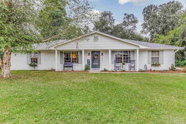 2519 Inda Ave, Pensacola, FL 32526 - ranch-style home with brick siding, covered porch, a front lawn, and roof with shingles