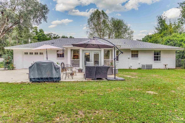 2519 Inda Ave, Pensacola, FL 32526 - rear view of house with cooling unit, brick siding, a yard, and an attached garage