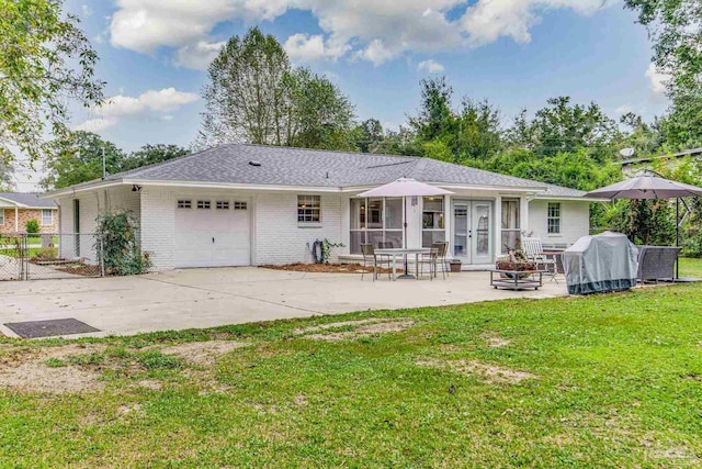 2519 Inda Ave, Pensacola, FL 32526 - back of property with a lawn, fence, french doors, an attached garage, and brick siding