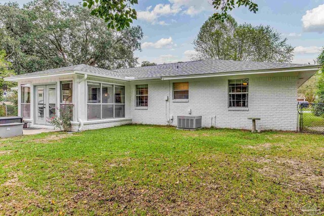 2519 Inda Ave, Pensacola, FL 32526 - rear view of property with a lawn, cooling unit, roof with shingles, a sunroom, and brick siding