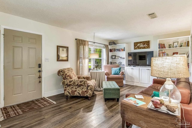 living room with hardwood / wood-style floors and a textured ceiling