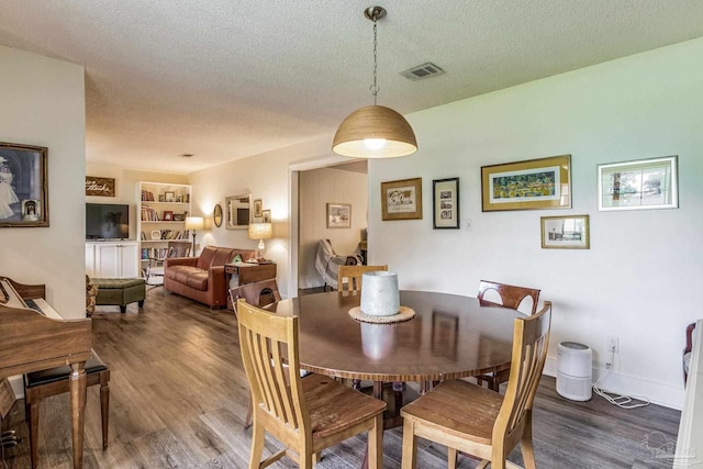2519 Inda Ave, Pensacola, FL 32526 - dining space with baseboards, wood finished floors, visible vents, and a textured ceiling