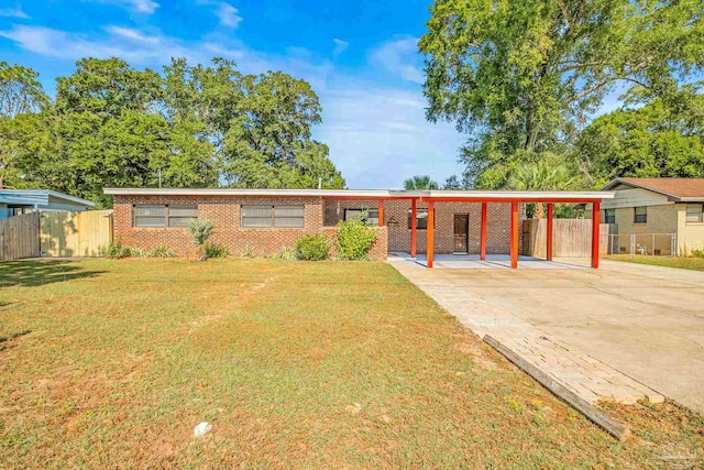 ranch-style house featuring a carport and a front yard