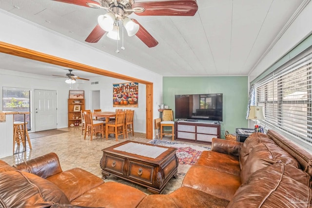 living room with crown molding, light tile patterned flooring, and ceiling fan