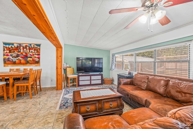 living room featuring lofted ceiling, crown molding, and ceiling fan