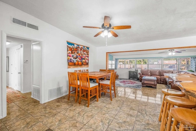 dining room featuring ceiling fan and vaulted ceiling