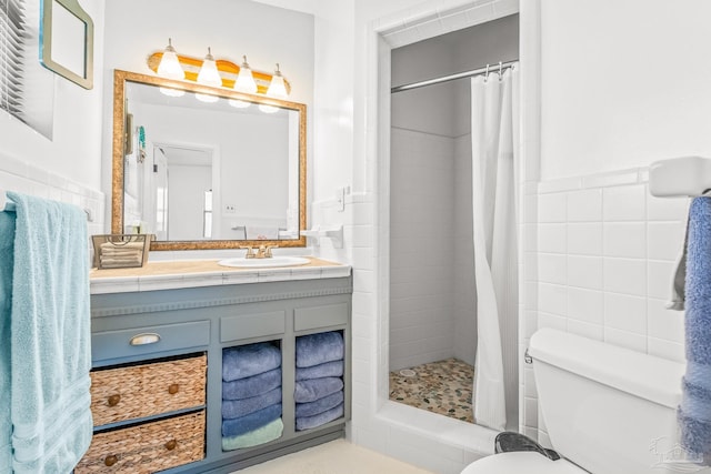 bathroom featuring vanity, toilet, tile walls, and a shower with curtain