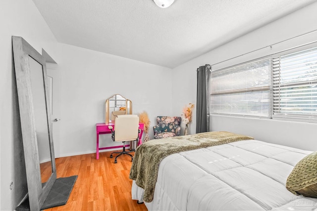 bedroom featuring a textured ceiling and hardwood / wood-style flooring