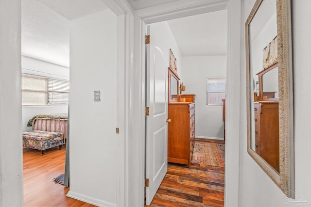 hallway with dark hardwood / wood-style floors