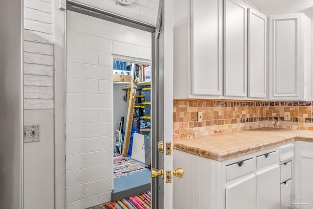 kitchen with white cabinets and tasteful backsplash