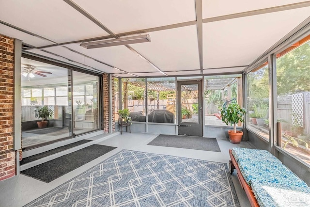 unfurnished sunroom featuring ceiling fan