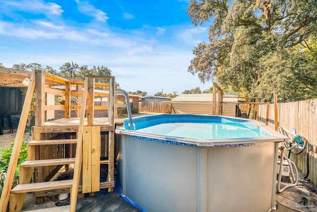 view of swimming pool with a storage unit