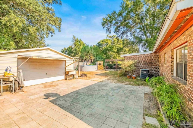 view of patio with an outdoor structure and a garage