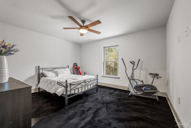 bedroom featuring a textured ceiling and ceiling fan