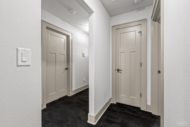 hall featuring dark colored carpet