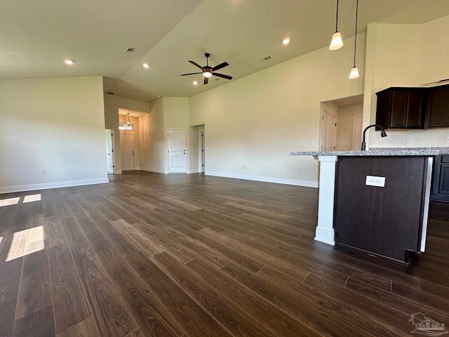interior space featuring dark wood-style flooring, open floor plan, and ceiling fan