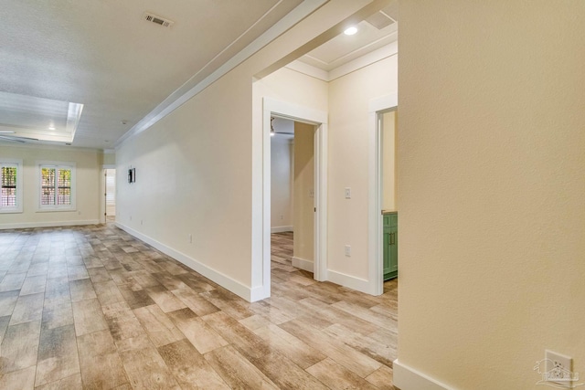 unfurnished room featuring light wood-type flooring and crown molding