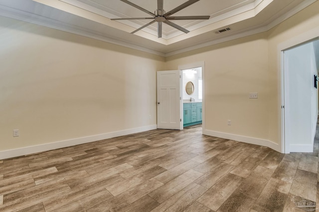 foyer entrance featuring a tray ceiling, ceiling fan, light wood-type flooring, and ornamental molding