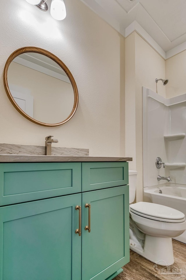 full bathroom with vanity, hardwood / wood-style floors, shower / bathing tub combination, and toilet