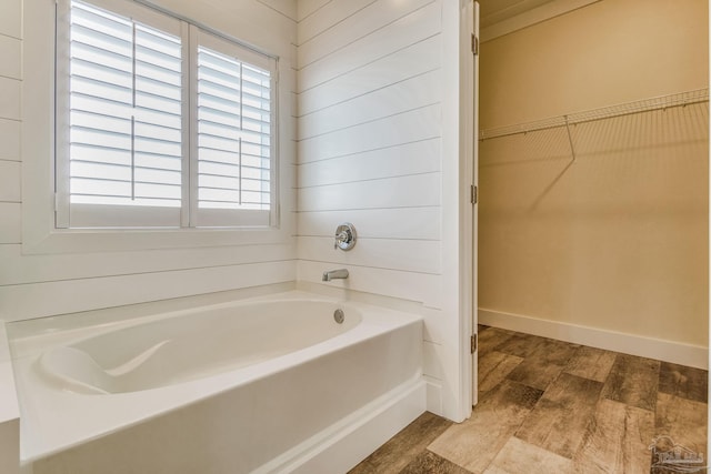 bathroom featuring a bath and hardwood / wood-style flooring