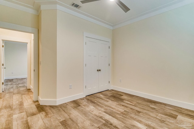 empty room with hardwood / wood-style floors, ceiling fan, and ornamental molding