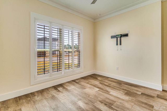 spare room featuring hardwood / wood-style floors and ornamental molding