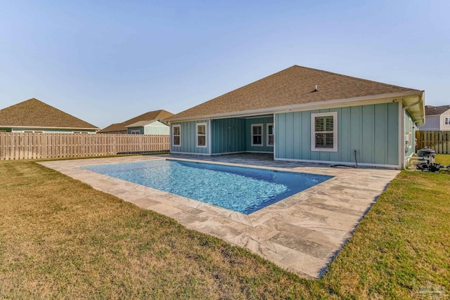 view of swimming pool with a lawn and a patio area