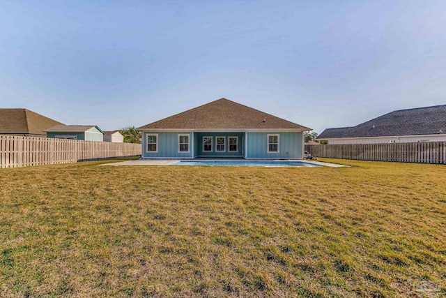 back of house featuring a lawn and a patio area