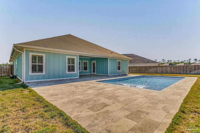 view of swimming pool featuring a lawn and a patio