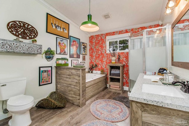 bathroom featuring a bath, hardwood / wood-style flooring, dual bowl vanity, crown molding, and toilet