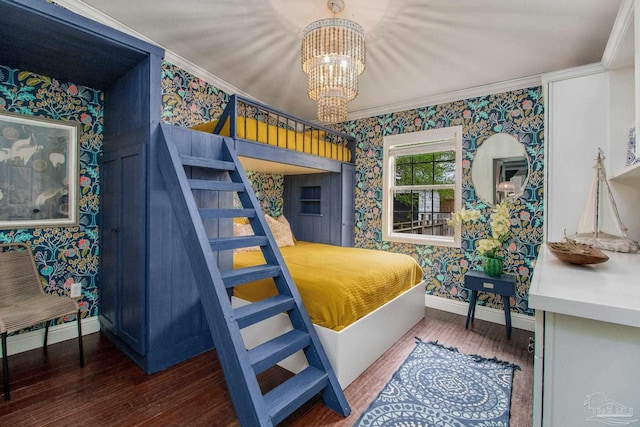 bedroom with an inviting chandelier, ornamental molding, and hardwood / wood-style flooring