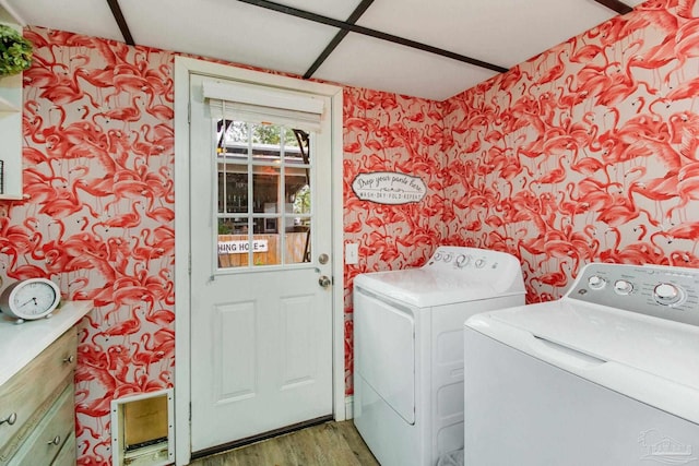 laundry area with independent washer and dryer and hardwood / wood-style floors