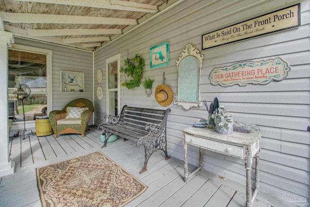 exterior space with vaulted ceiling with beams