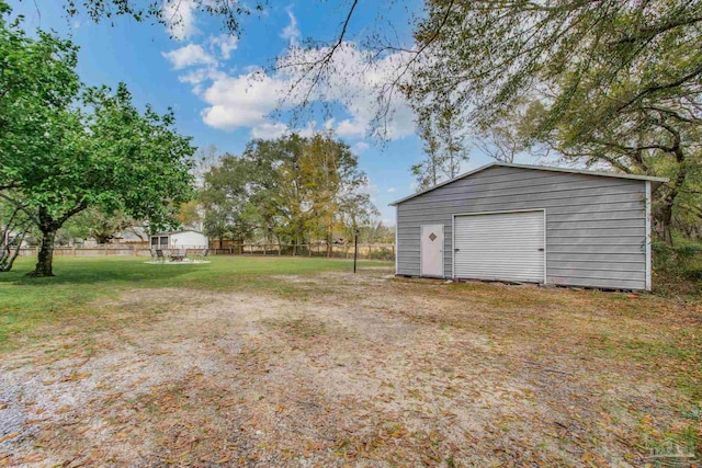 view of yard with a garage and an outdoor structure