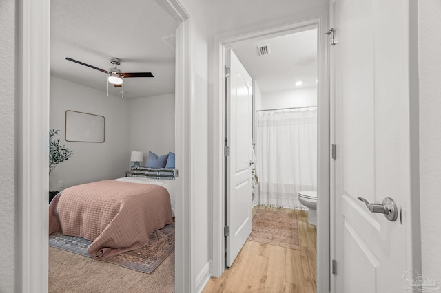 8820 Smiley Ct, Pensacola, FL 32514 - bedroom with connected bathroom and light wood-style floors