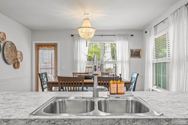 8820 Smiley Ct, Pensacola, FL 32514 - kitchen featuring a chandelier, light countertops, and pendant lighting
