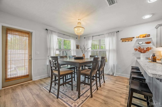 8820 Smiley Ct, Pensacola, FL 32514 - dining space with a chandelier and light wood-style flooring