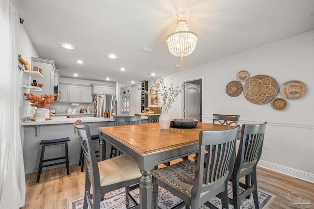 8820 Smiley Ct, Pensacola, FL 32514 - dining space with light wood-style floors, a chandelier, and recessed lighting