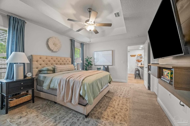 8820 Smiley Ct, Pensacola, FL 32514 - carpeted bedroom with a tray ceiling and a ceiling fan