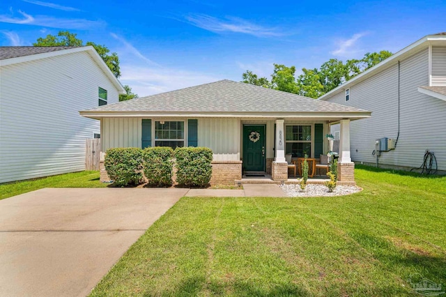 8820 Smiley Ct, Pensacola, FL 32514 - view of front of property featuring covered porch, a shingled roof, a front yard, board and batten siding, and brick siding