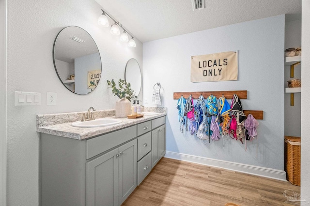 8820 Smiley Ct, Pensacola, FL 32514 - full bathroom featuring double vanity and wood finished floors