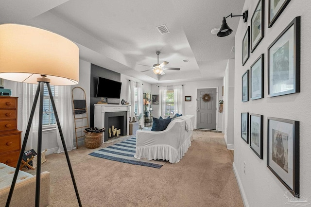 8820 Smiley Ct, Pensacola, FL 32514 - living room featuring a fireplace, carpet flooring, a ceiling fan, and a tray ceiling