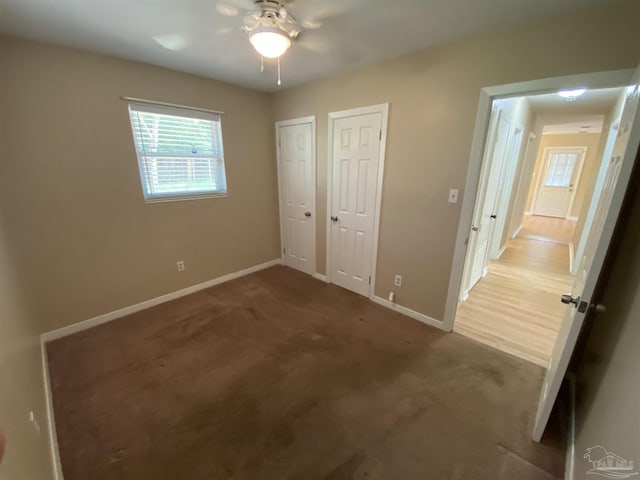 925 Artesian Ave, Pensacola, FL 32505 - unfurnished bedroom featuring multiple closets, baseboards, carpet, and ceiling fan