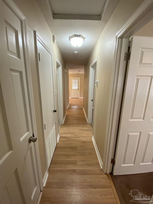 925 Artesian Ave, Pensacola, FL 32505 - corridor with light wood-style floors, baseboards, and a textured ceiling